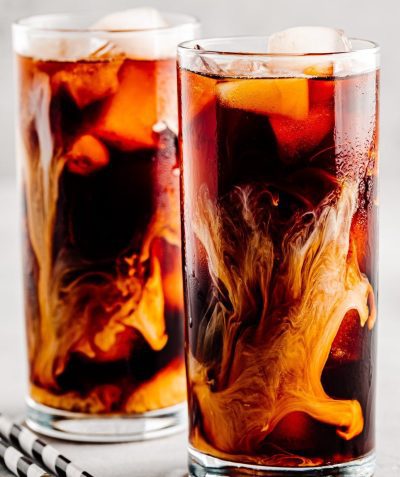 Coconut iced coffee with ice cubes in tall glasses